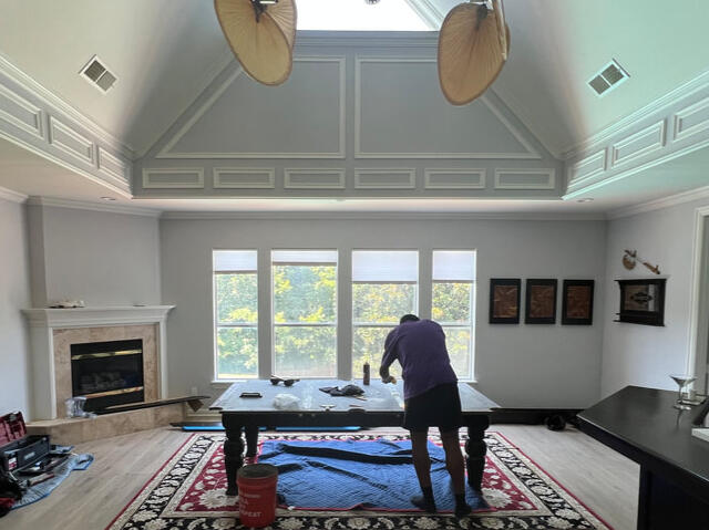 Top Texas Billiards Technicians are working on a pool table in a grand room.